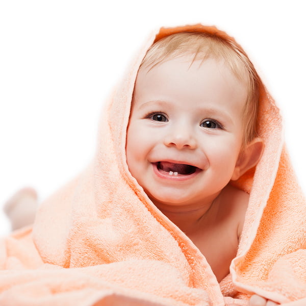 A smiling baby wrapped snugly in a bright orange towel, radiating joy and warmth